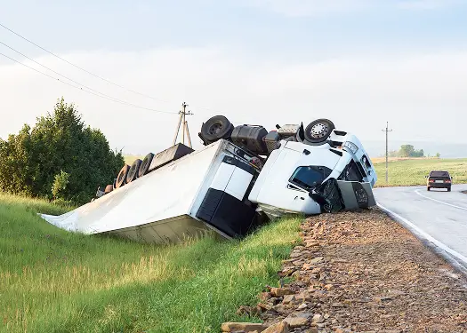 Overturned semi-truck on roadside, accident scene